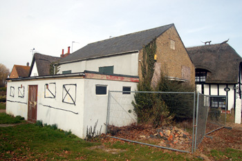 5 Beeston Green peers out from behind the derelict Village Hall March 2010